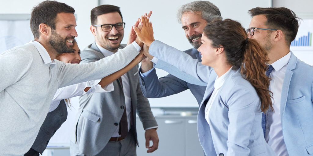 Multiple, happy coworkers doing a high five