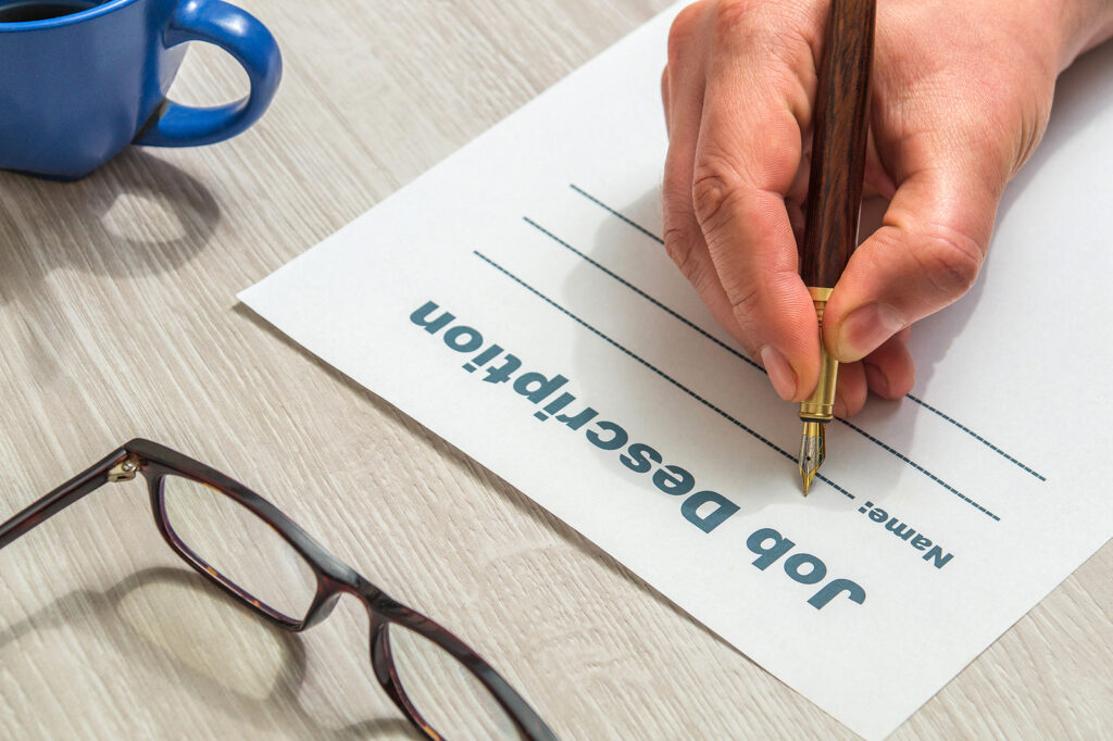Person fills out a job description form before looking for good job